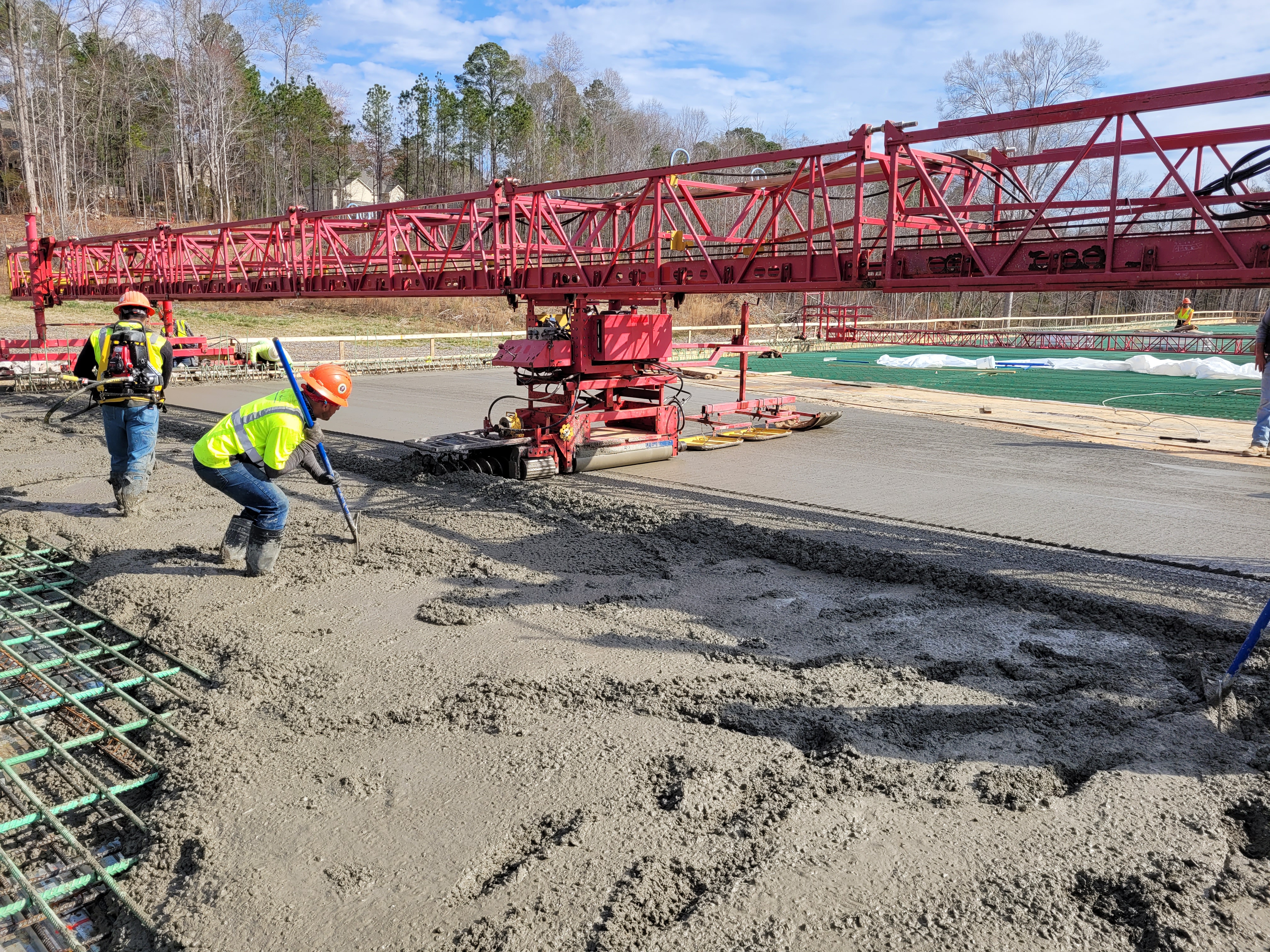 workers spreading concrete 